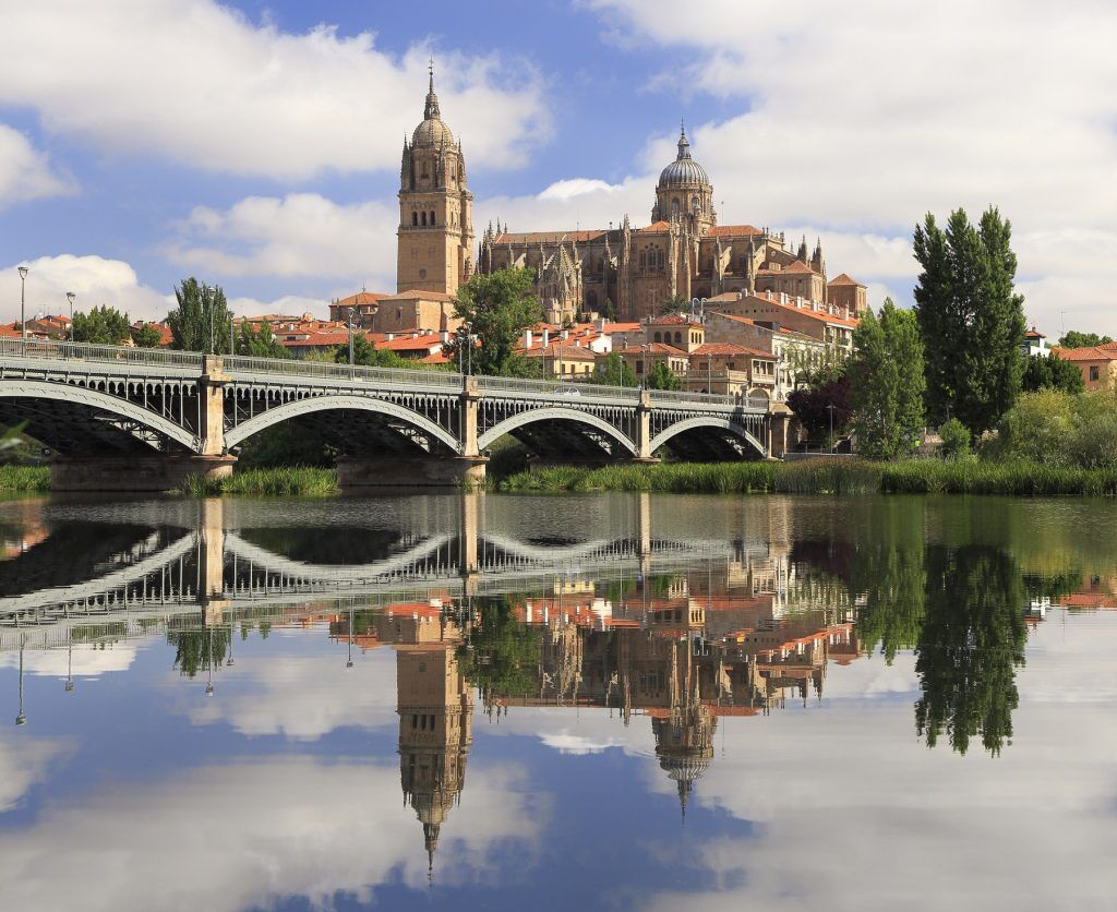 Salamanca Old and New Cathedrales reflected on Tormes River, Spain